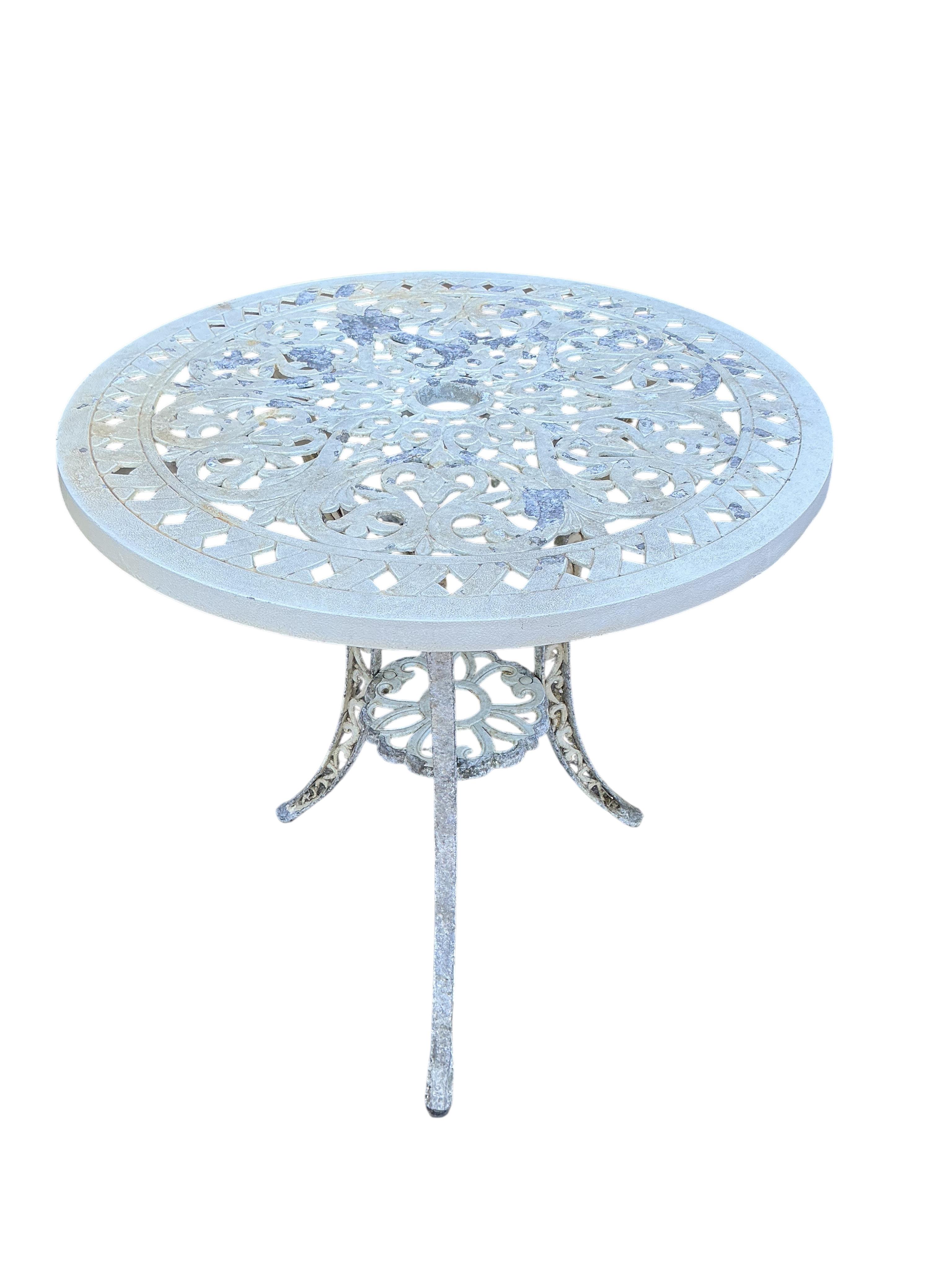 A Victorian style circular painted aluminium garden table, diameter 66cm, height 71cm and two similar garden chairs